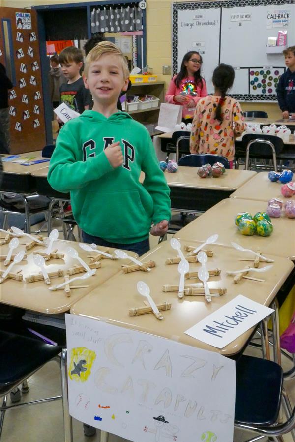 boy selling spoon catapults